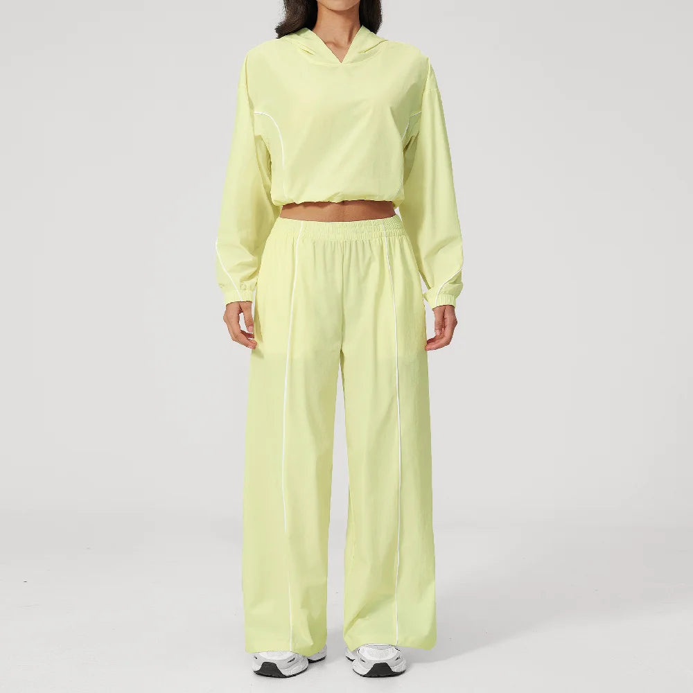 Women’s lemon yellow hooded sports set with contrast piping, cropped jacket and wide-leg pants