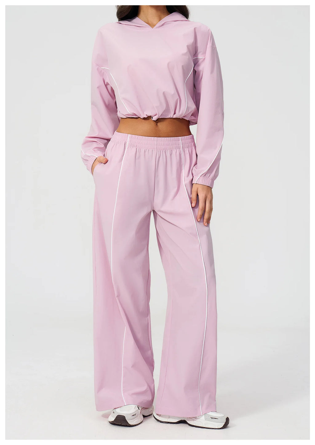 Women’s light pink hooded windbreaker crop top and wide-leg pants set