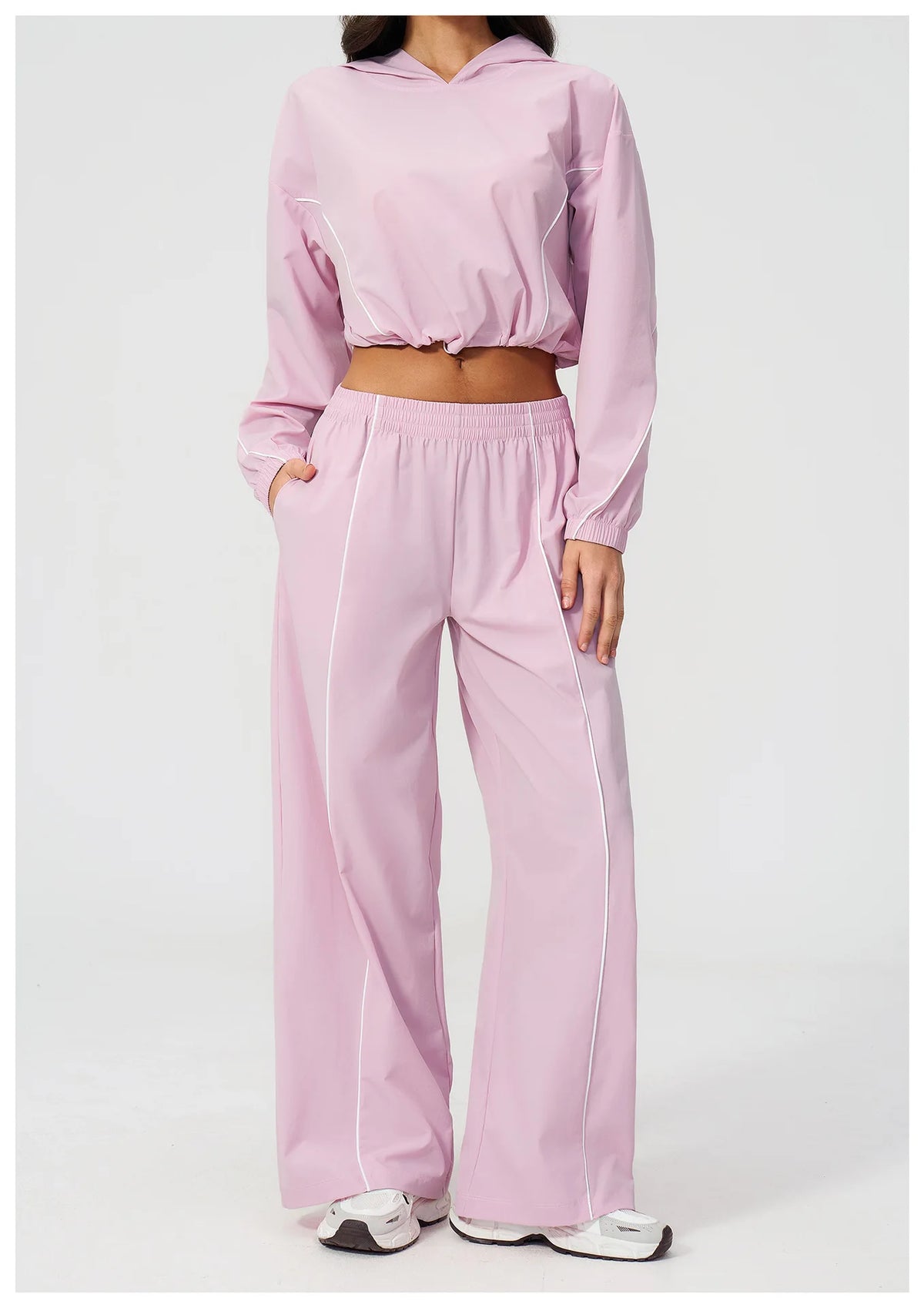 Women’s light pink hooded windbreaker crop top and wide-leg pants set
