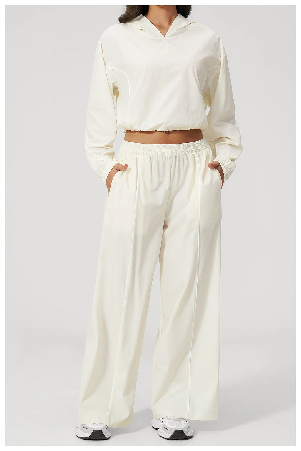 Women’s cream hooded windbreaker crop top and wide-leg pants set, front view 