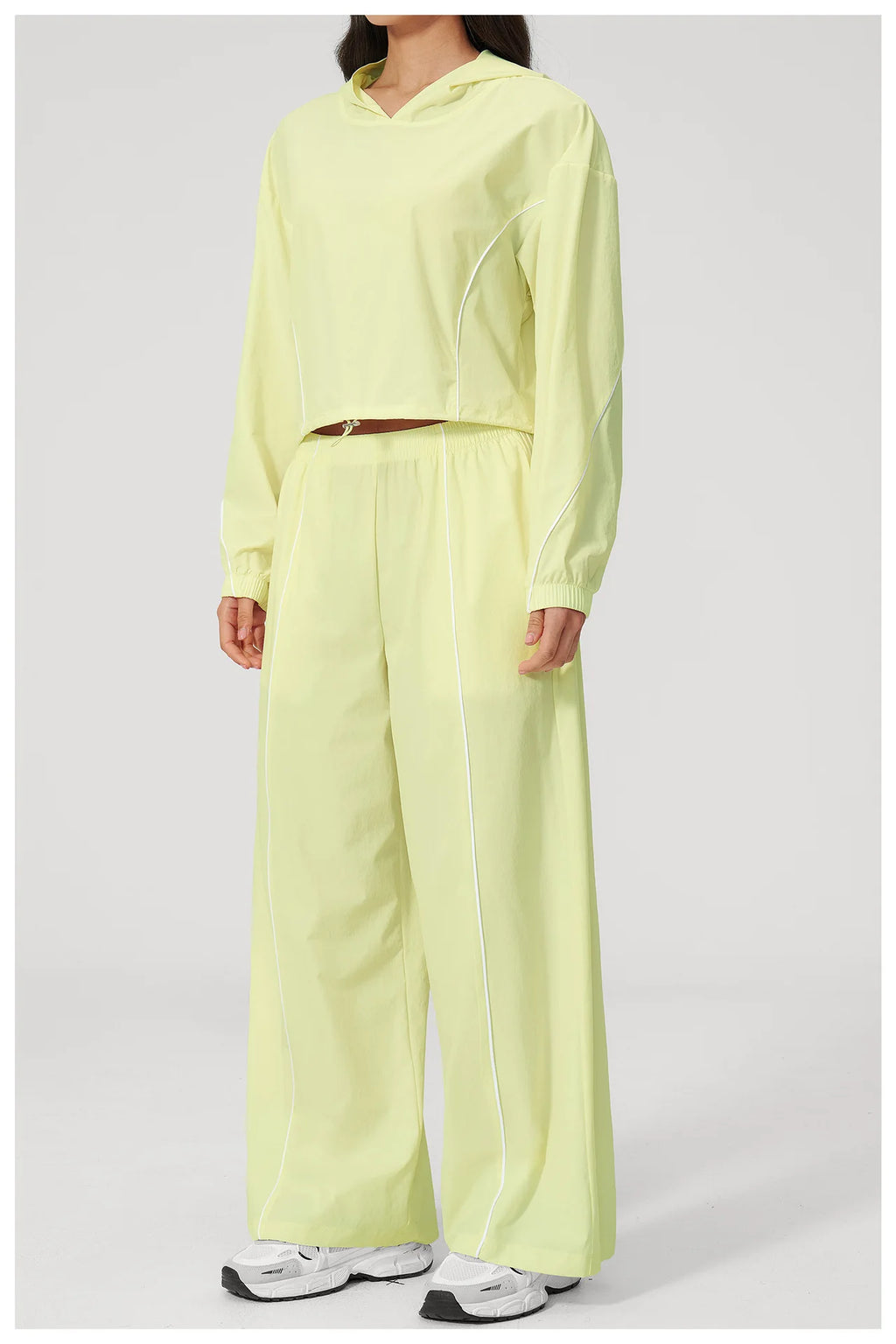 Women’s lemon yellow hooded windbreaker crop top and wide-leg pants set, front view