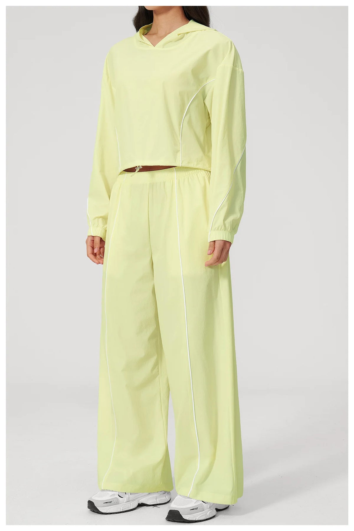 Women’s lemon yellow hooded windbreaker crop top and wide-leg pants set, front view