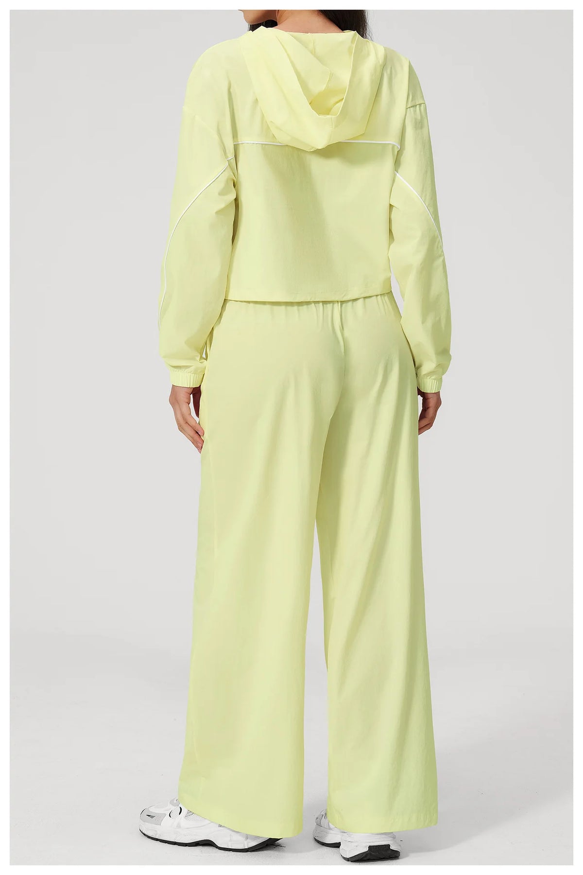 Women’s lemon yellow hooded windbreaker crop top and wide-leg pants set, back view
