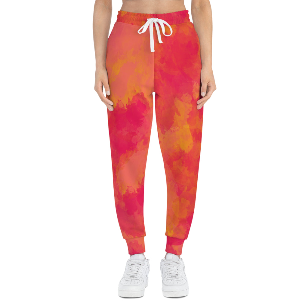 Pink-orange tie-dye sweatpants with white drawstring, tapered fit and ankle cuffs