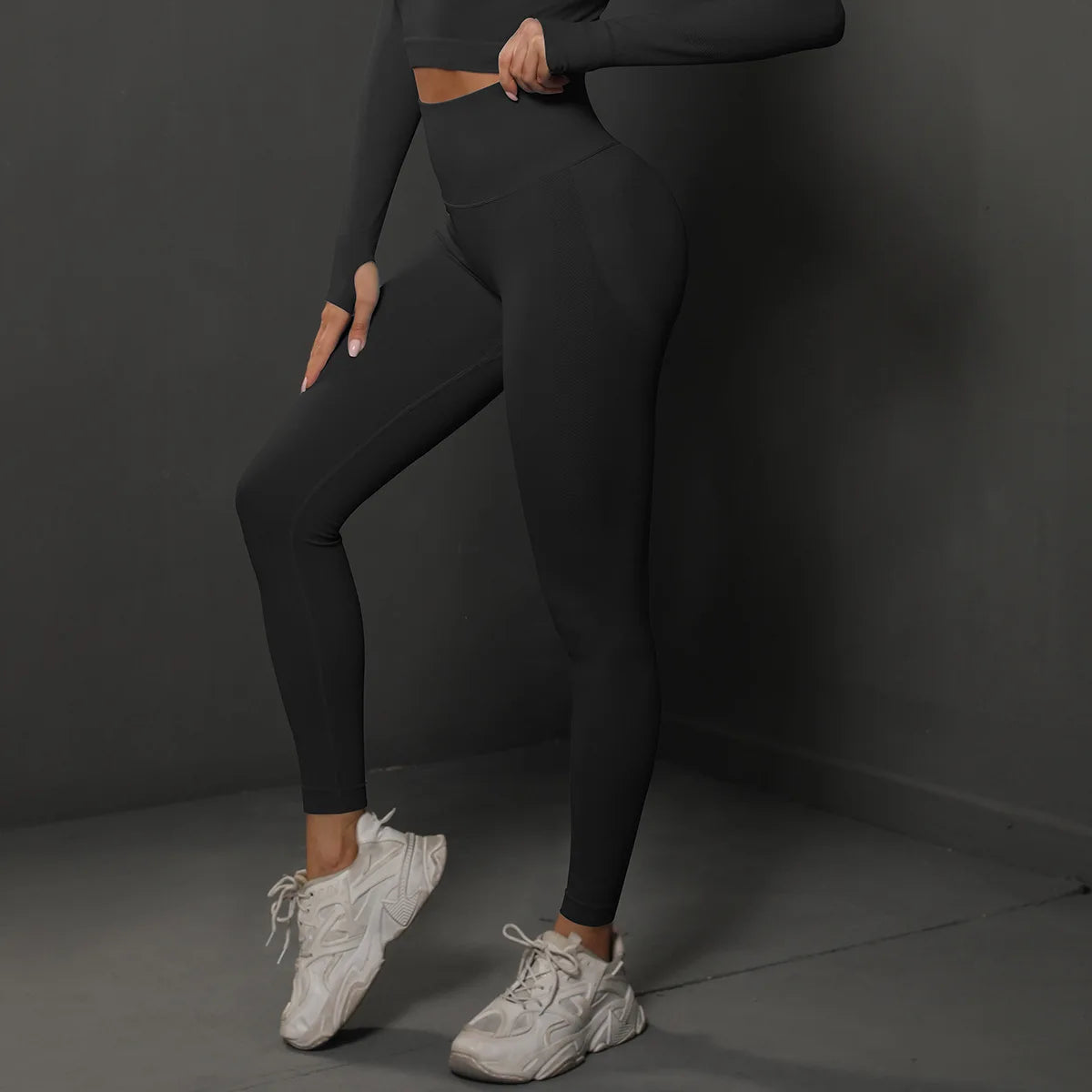 High-waist black yoga leggings, full-length, side view with fitted seams at the legs