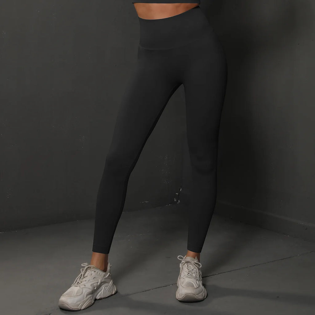 High-waist black yoga leggings, full-length fitted legs with smooth waistband