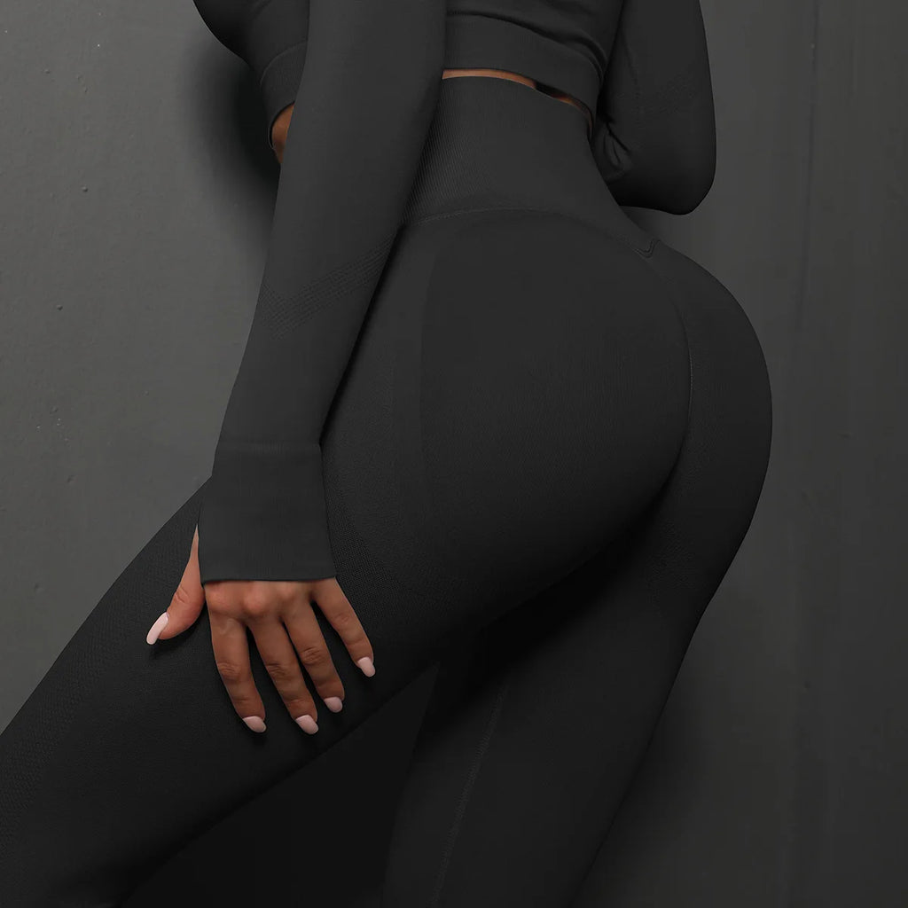 High-waist black yoga leggings, back close-up highlighting the fitted seat and leg curve