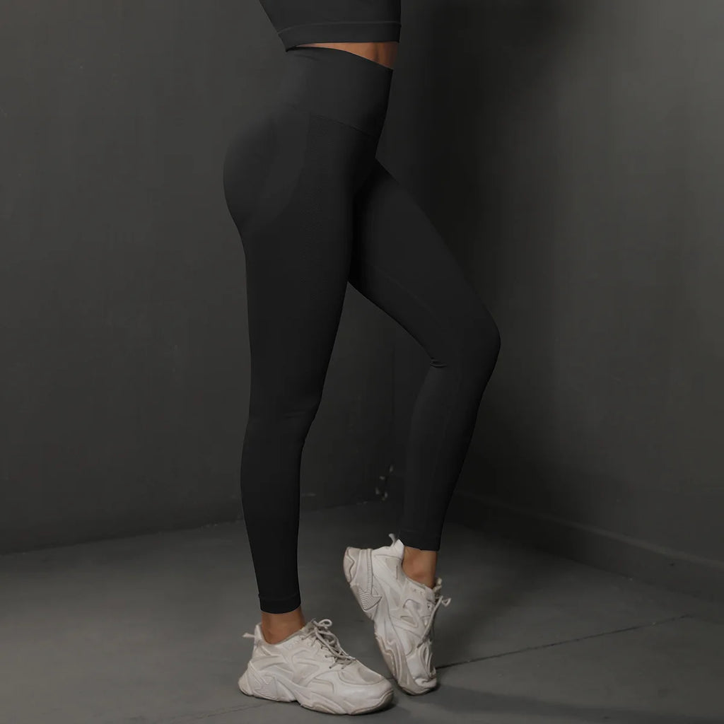 High-waist black leggings with fitted leg panels and full-length stretch fabric
