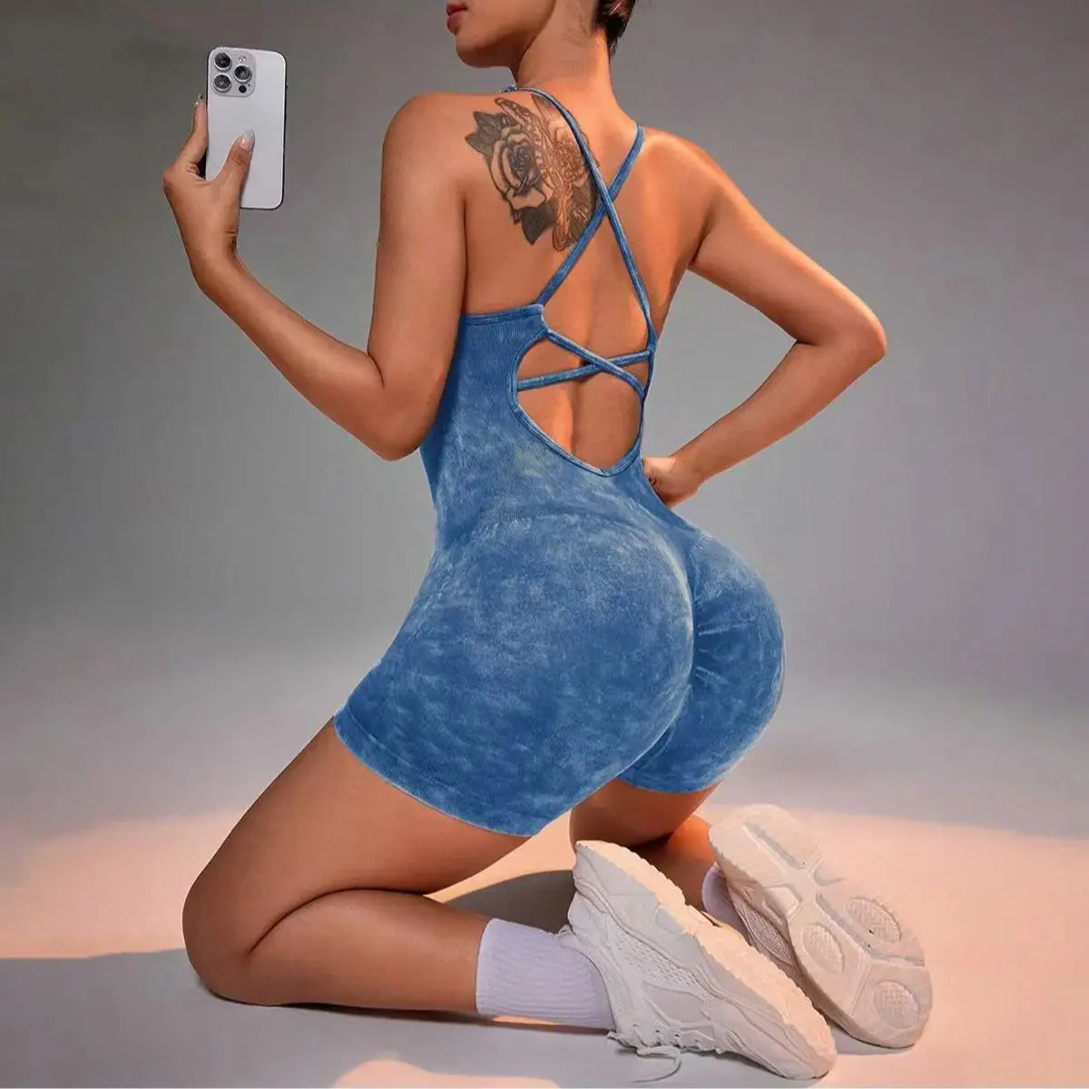 Washed blue strappy yoga romper, open back crisscross straps and scoop front