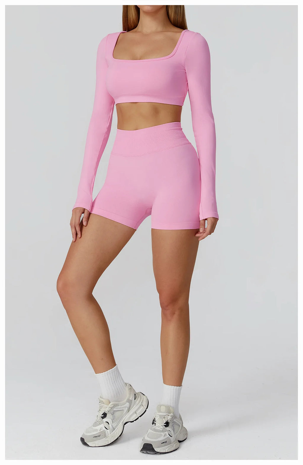Xooie Fit two-piece set featuring a long sleeve gym crop top and shorts in pink for stylish workouts
