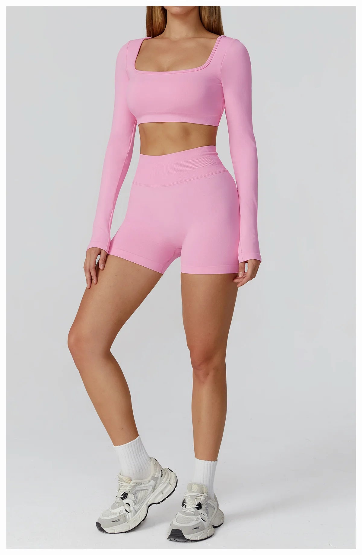 Xooie Fit two-piece set featuring a long sleeve gym crop top and shorts in pink for stylish workouts