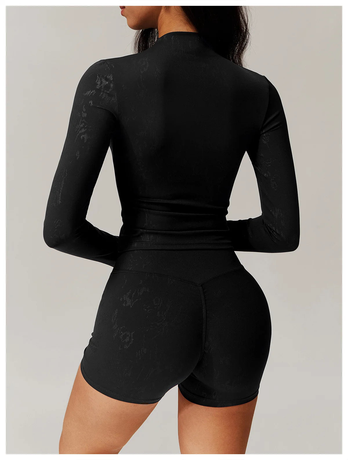 Embossed active matching set, textured black fitted long sleeve top and shorts, back view