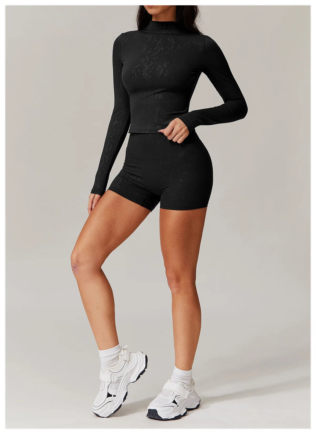 Embossed active matching set, textured black fitted long sleeve top and shorts, front view