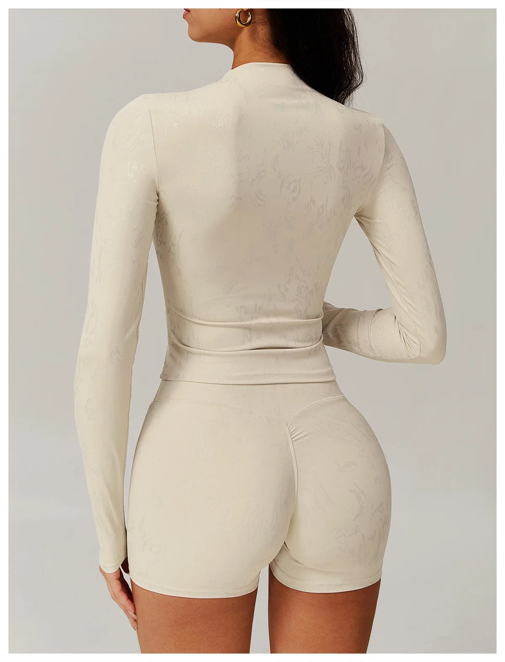 Light ivory textured long-sleeve fitted top and matching high-waist shorts set, back view