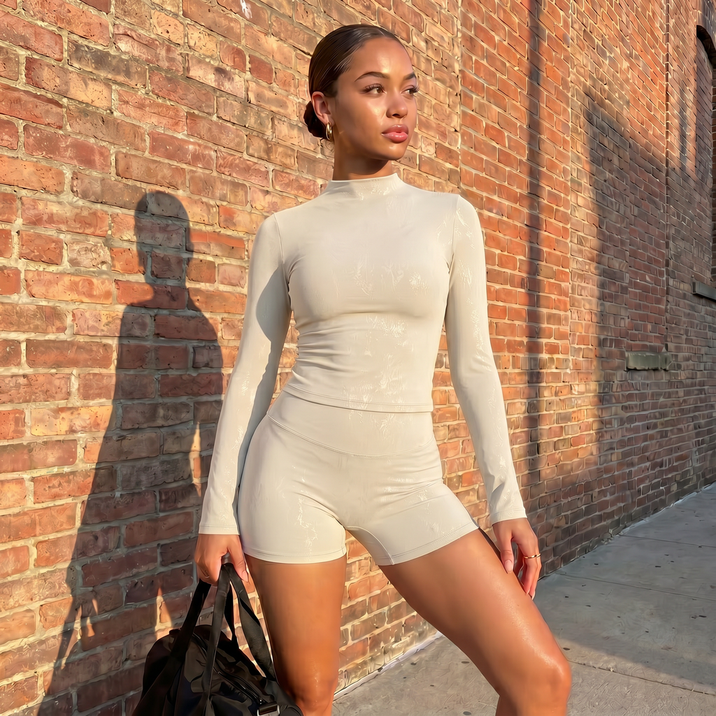 Light ivory textured long-sleeve fitted top and matching high-waist shorts set