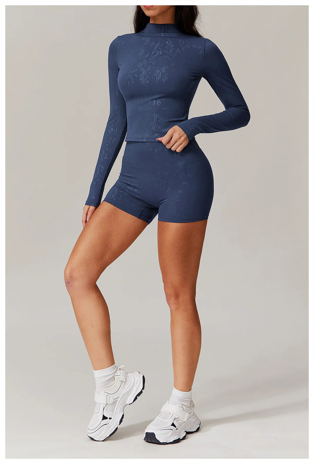 Navy blue textured long-sleeve fitted top and matching high-waist shorts set, full body