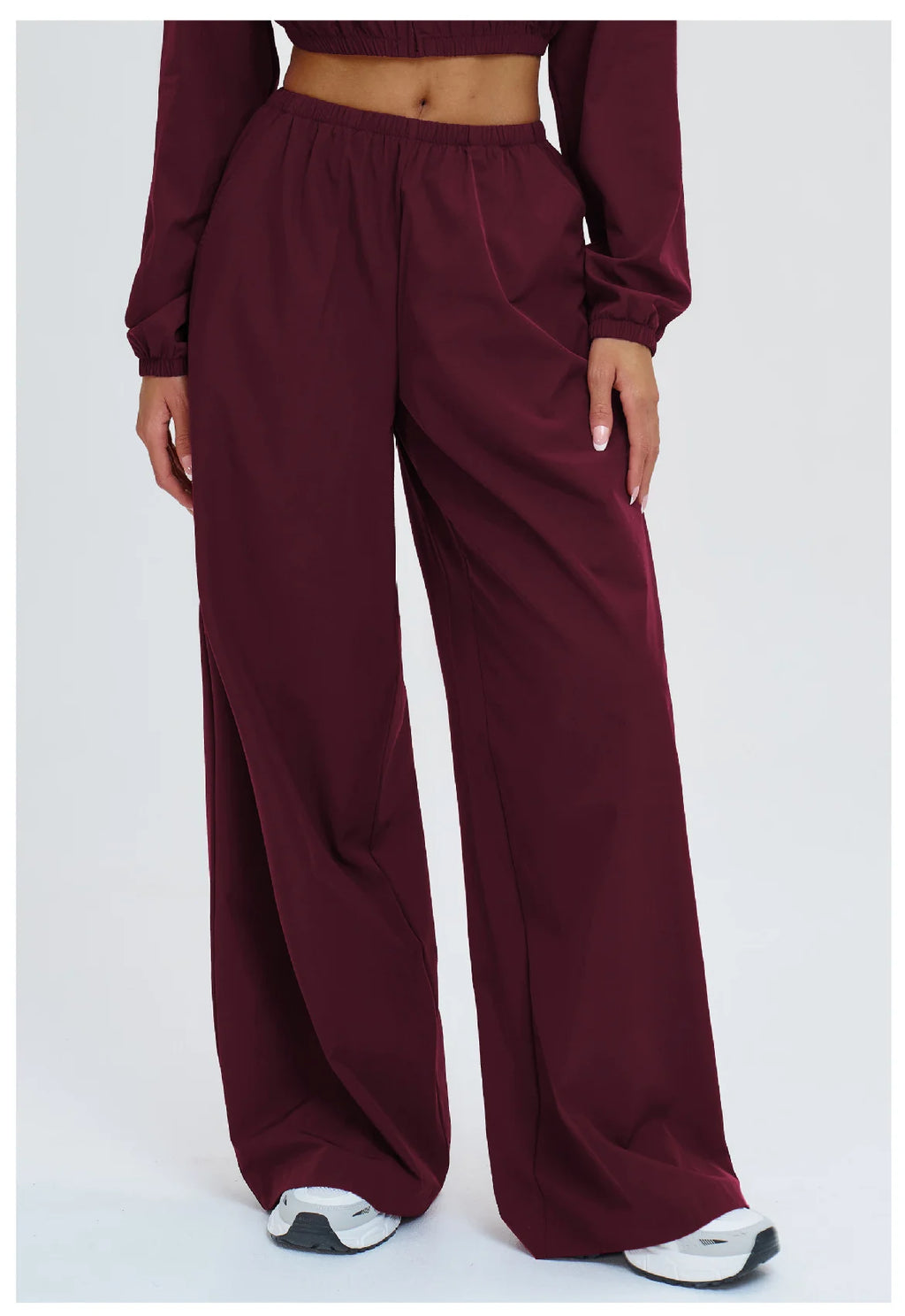 Burgundy wide-leg sports pants with elastic waist and side pocket detail