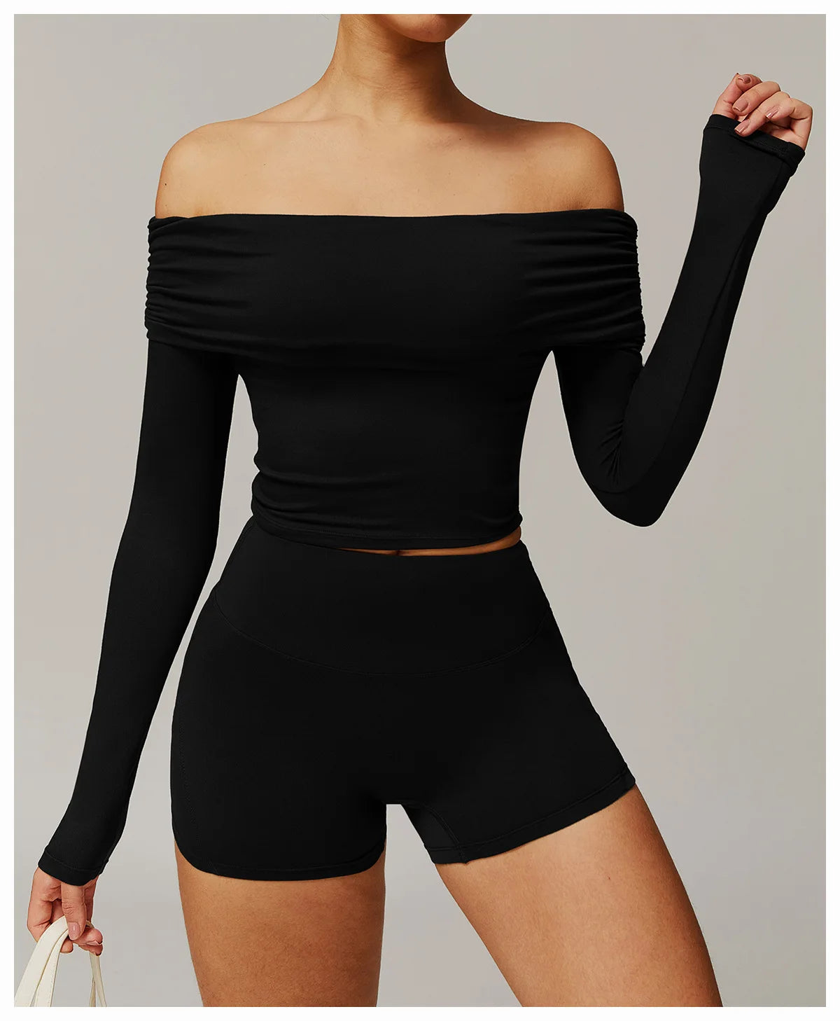 Xooie Fit off shoulder workout set in black featuring a long sleeve crop top and high waist shorts