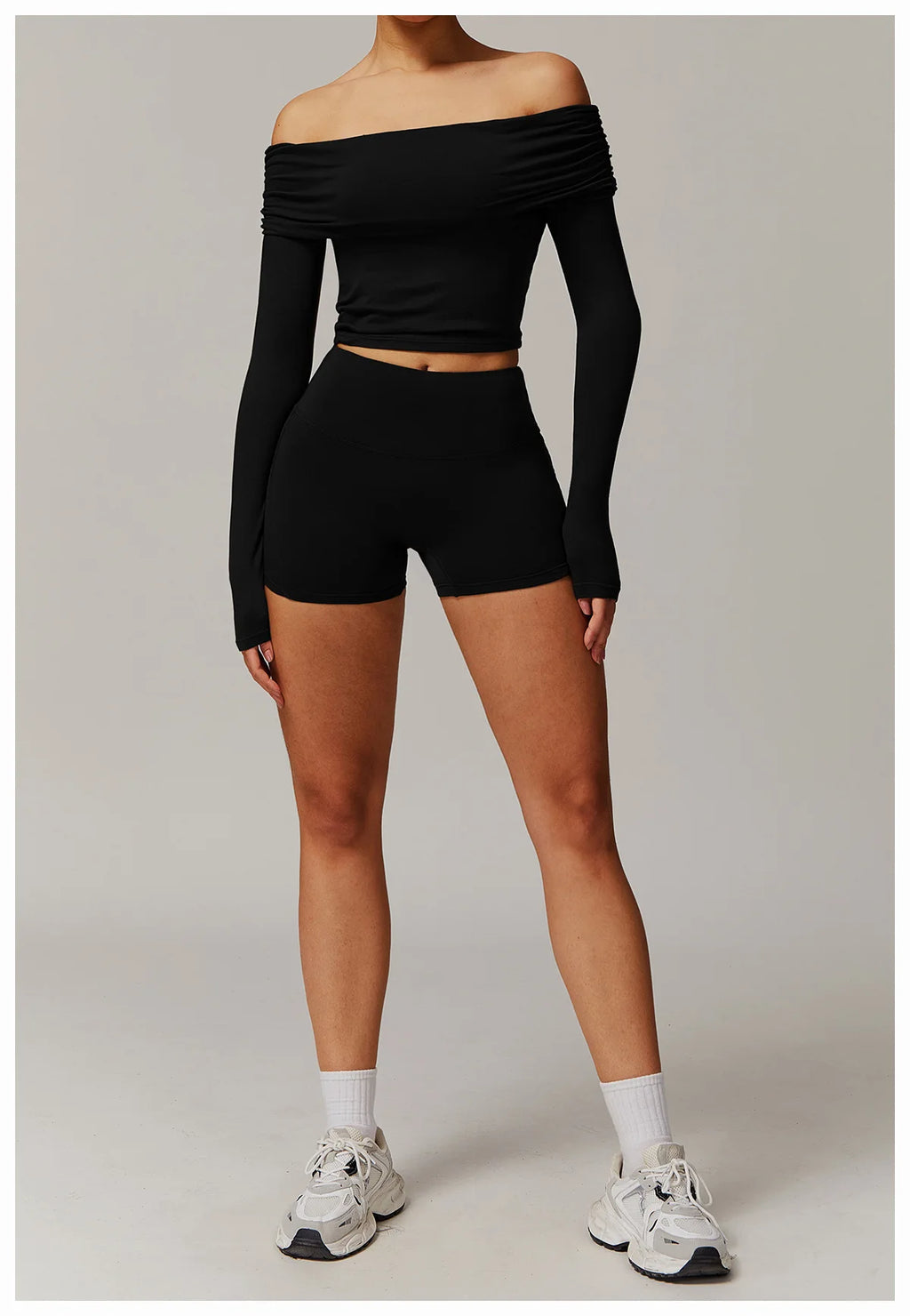 Xooie Fit black off shoulder workout set with long sleeves and high-waisted shorts worn by model