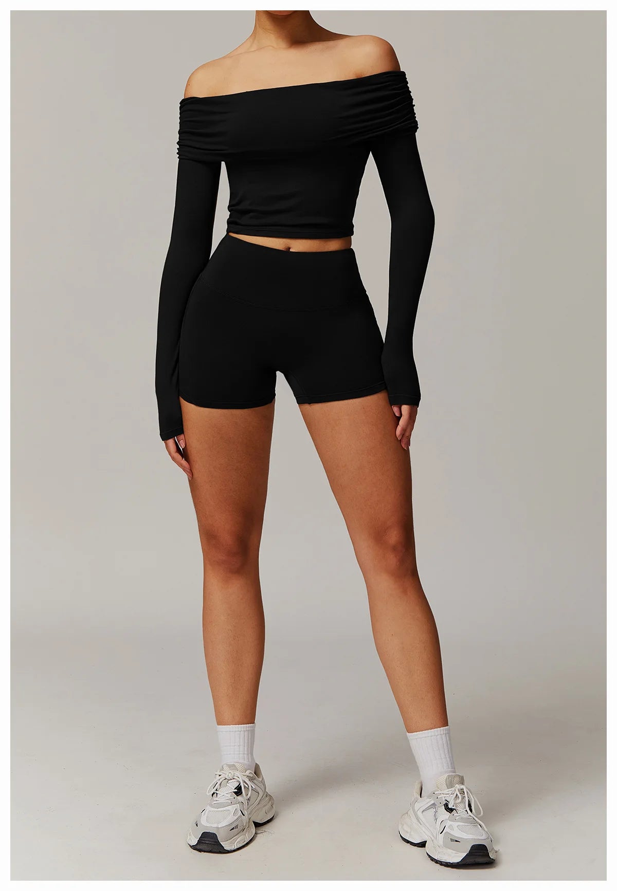 Xooie Fit black off shoulder workout set with long sleeves and high-waisted shorts worn by model