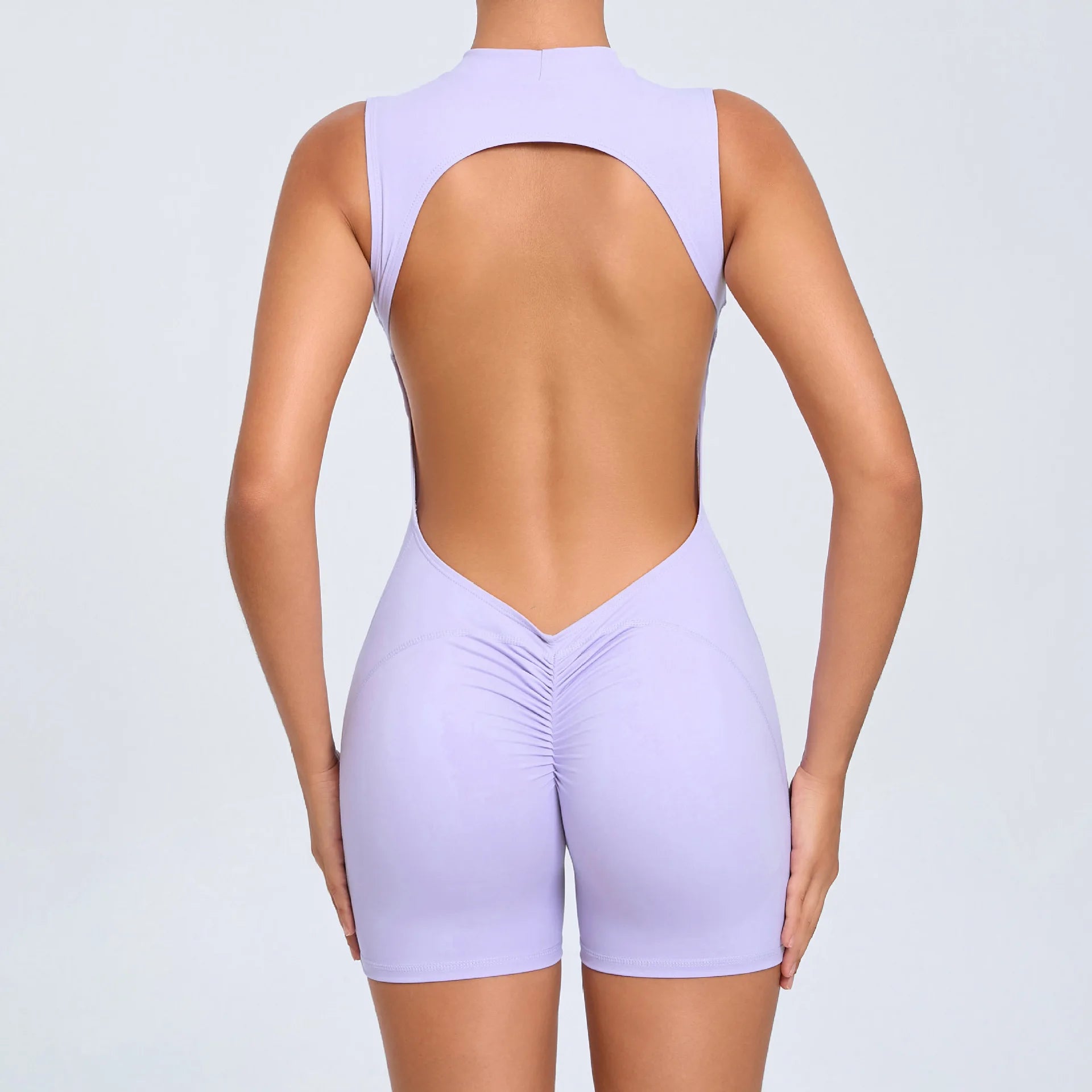 Xooie Fit open-back romper for workouts in light purple with a flattering fit and stylish design