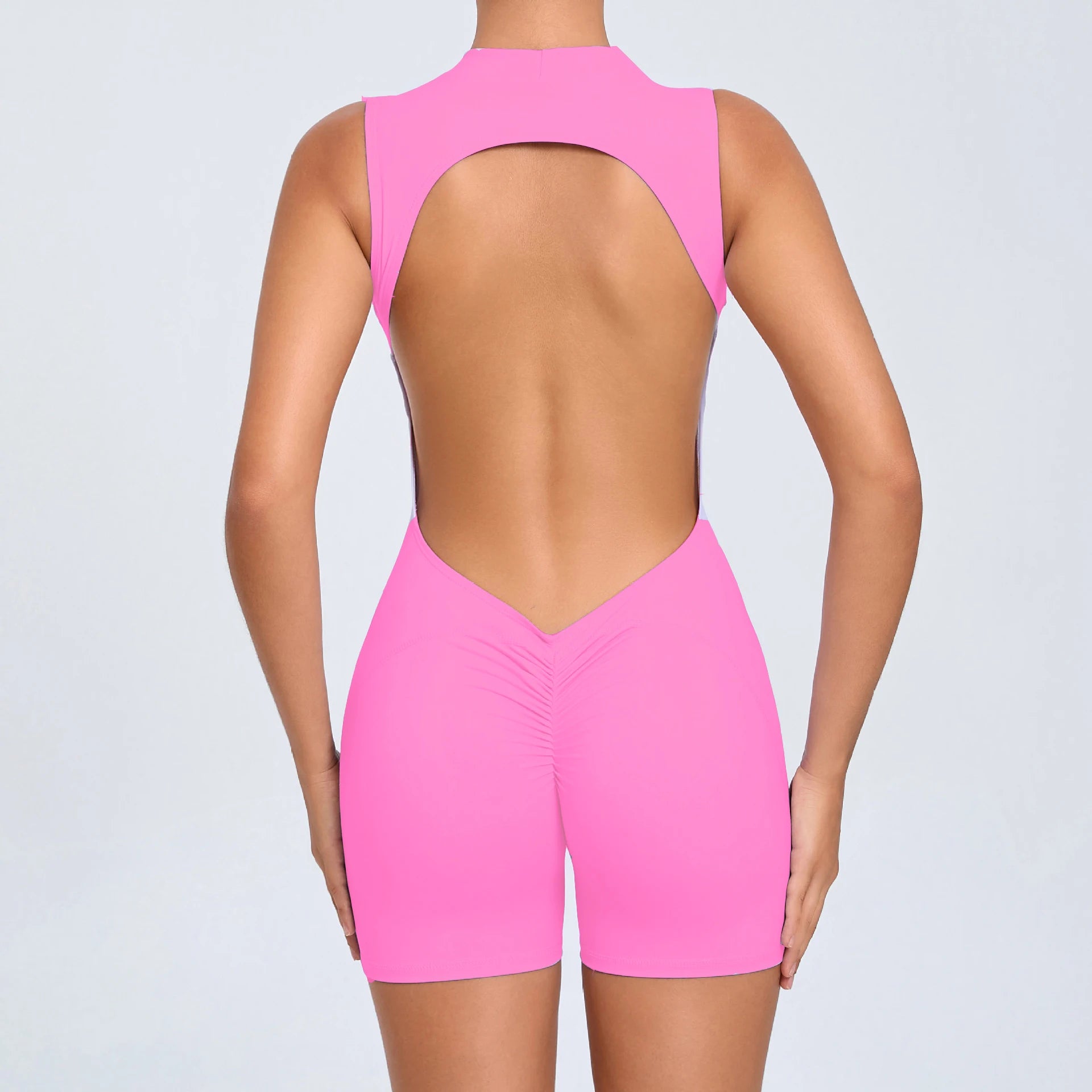 Pink Xooie Fit open-back romper for workouts featuring a stylish back design
