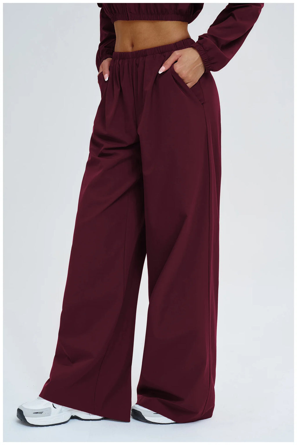 Burgundy wide-leg yoga pants with side pockets and loose, draping fit