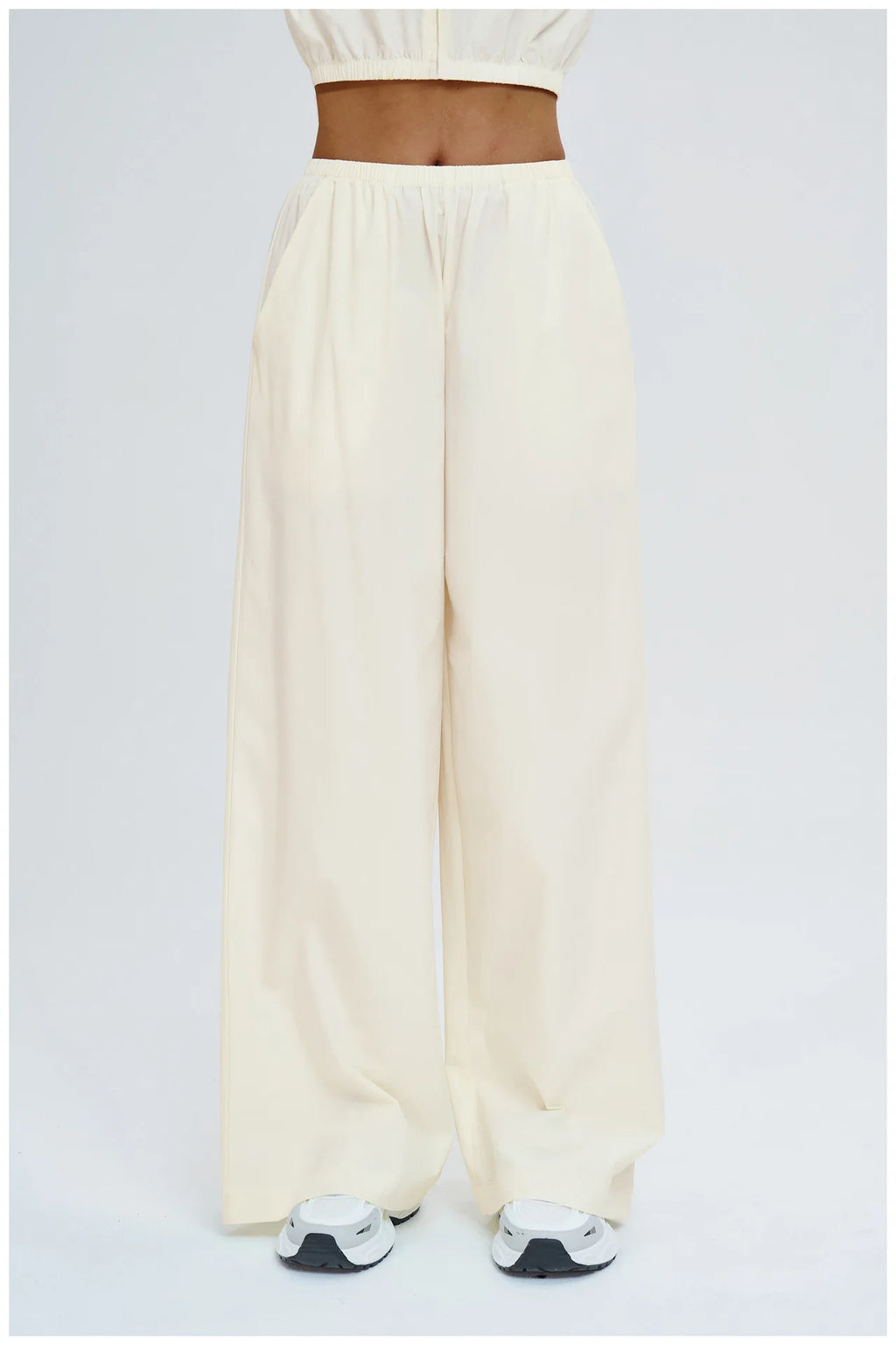 Light cream wide-leg pants with elastic waistband and straight relaxed legs