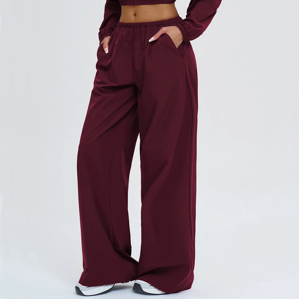 Burgundy wide-leg yoga pants with elastic waistband and side pockets