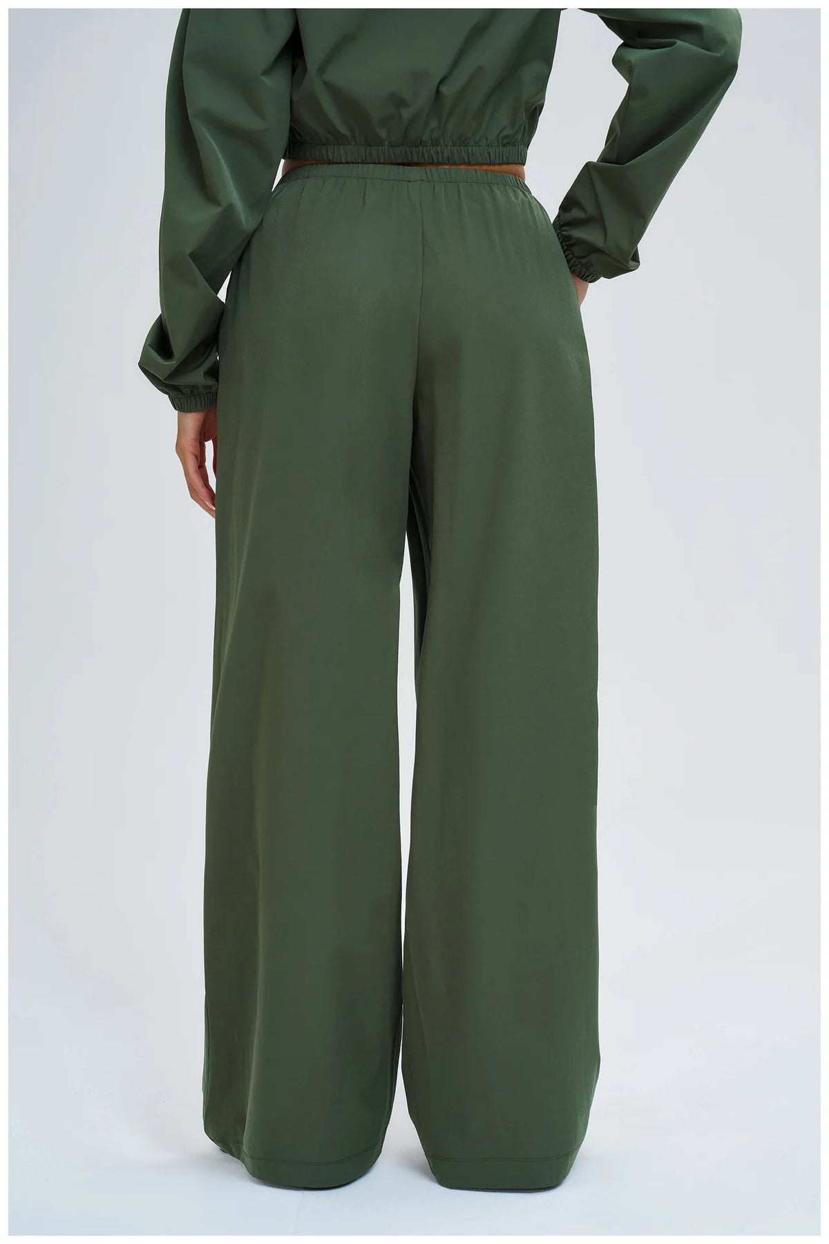 Dark green wide-leg pants with elastic waistband, back view and roomy fit
