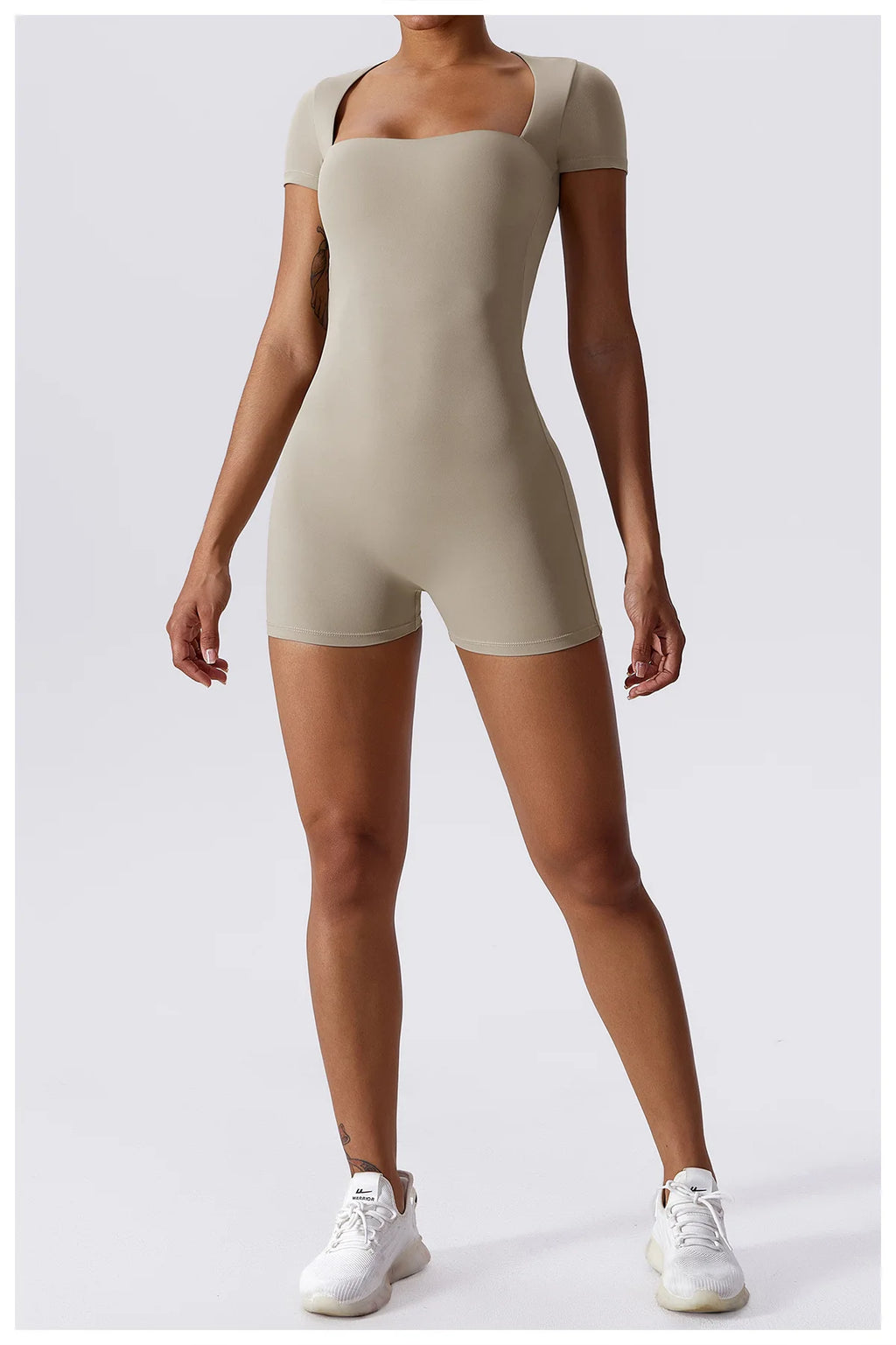 Women's beige short one-piece yoga suit with short sleeves and built-in shorts