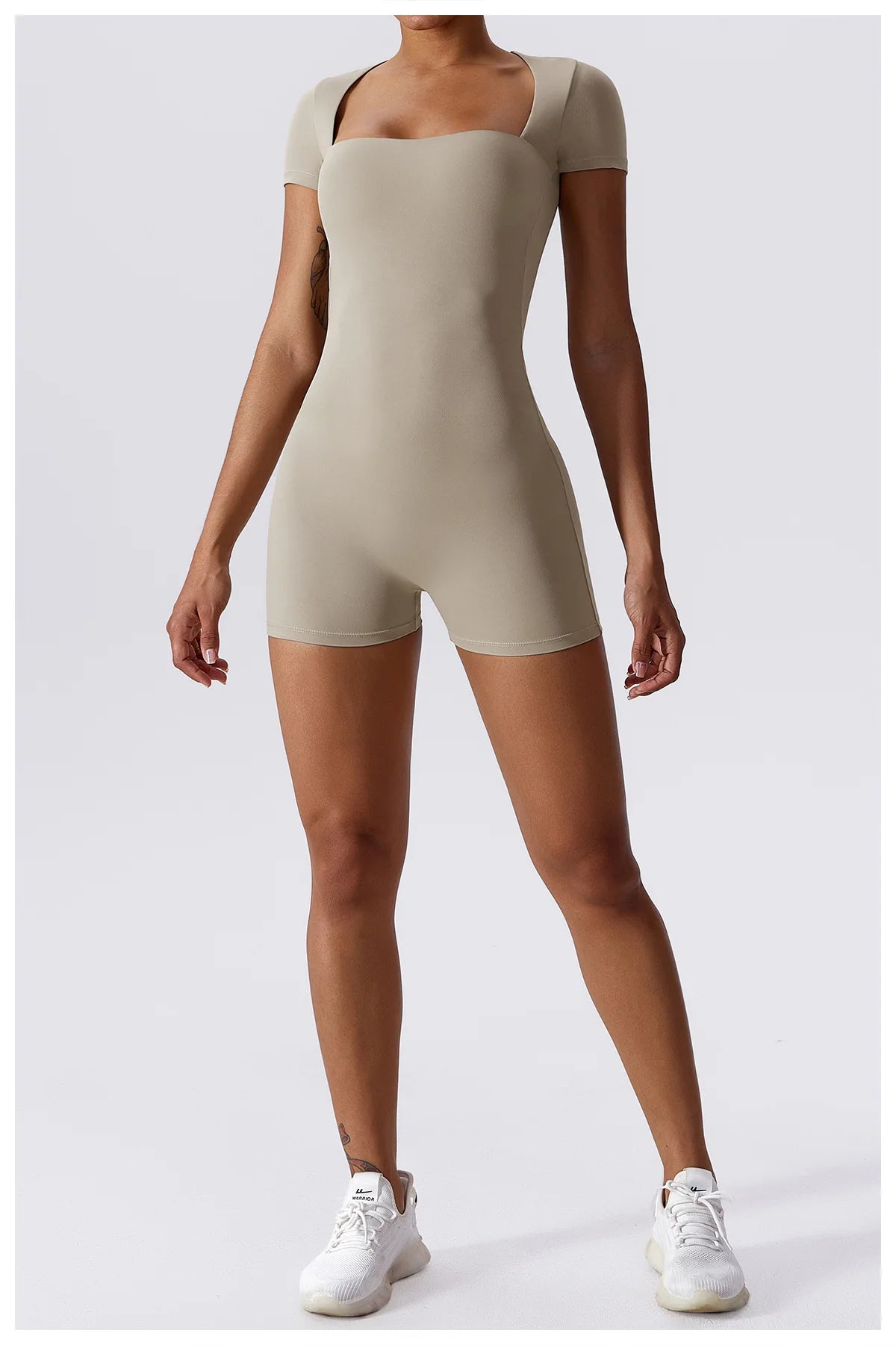 Women's beige short one-piece yoga suit with short sleeves and built-in shorts