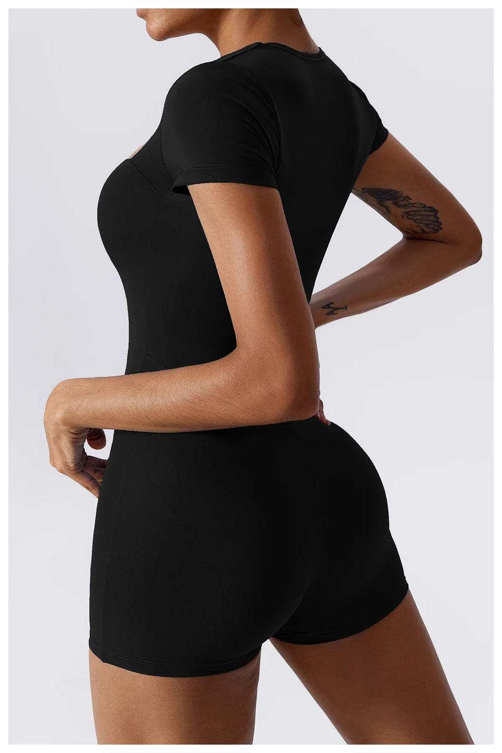 Women's black short one-piece yoga suit, back and side view with short sleeves