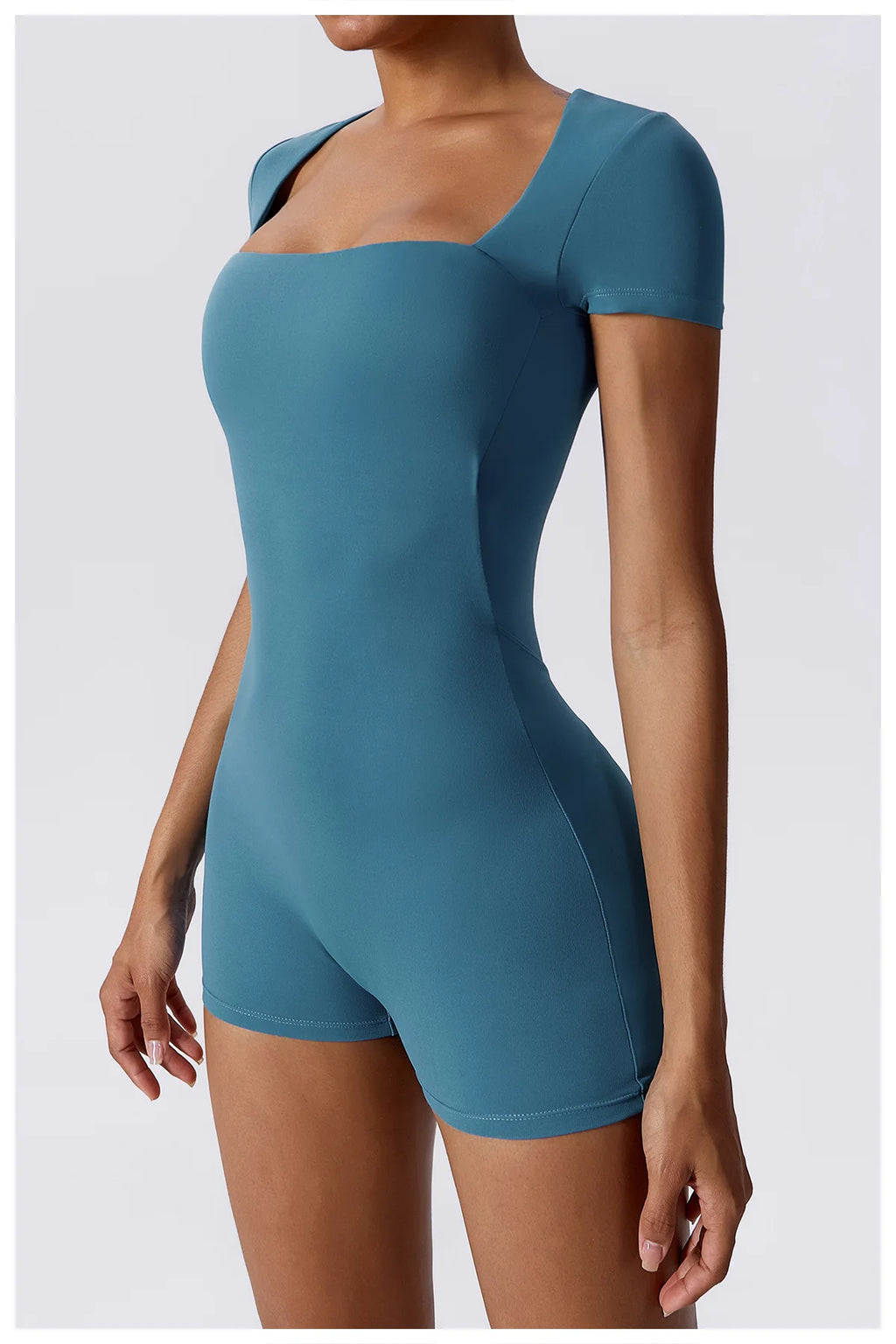 Women's teal short one-piece yoga suit, close front view with short sleeves