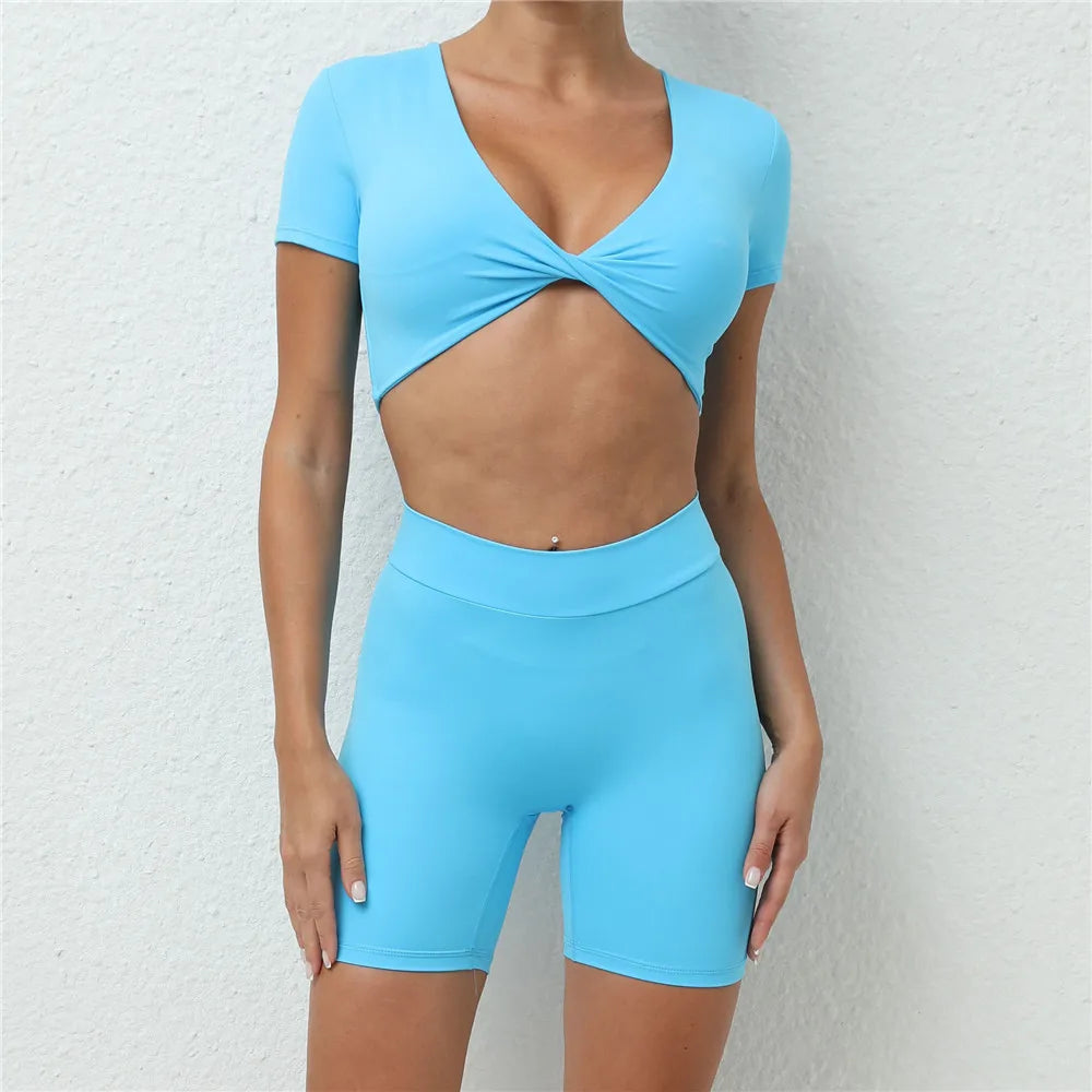 Xooie Fit short sleeve crop top and shorts set in light blue with twist front crop top and high-waisted biker shorts