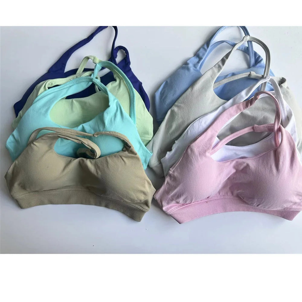 Xooie Fit collection of side-strap bra and leggings in various colors hanging on display
