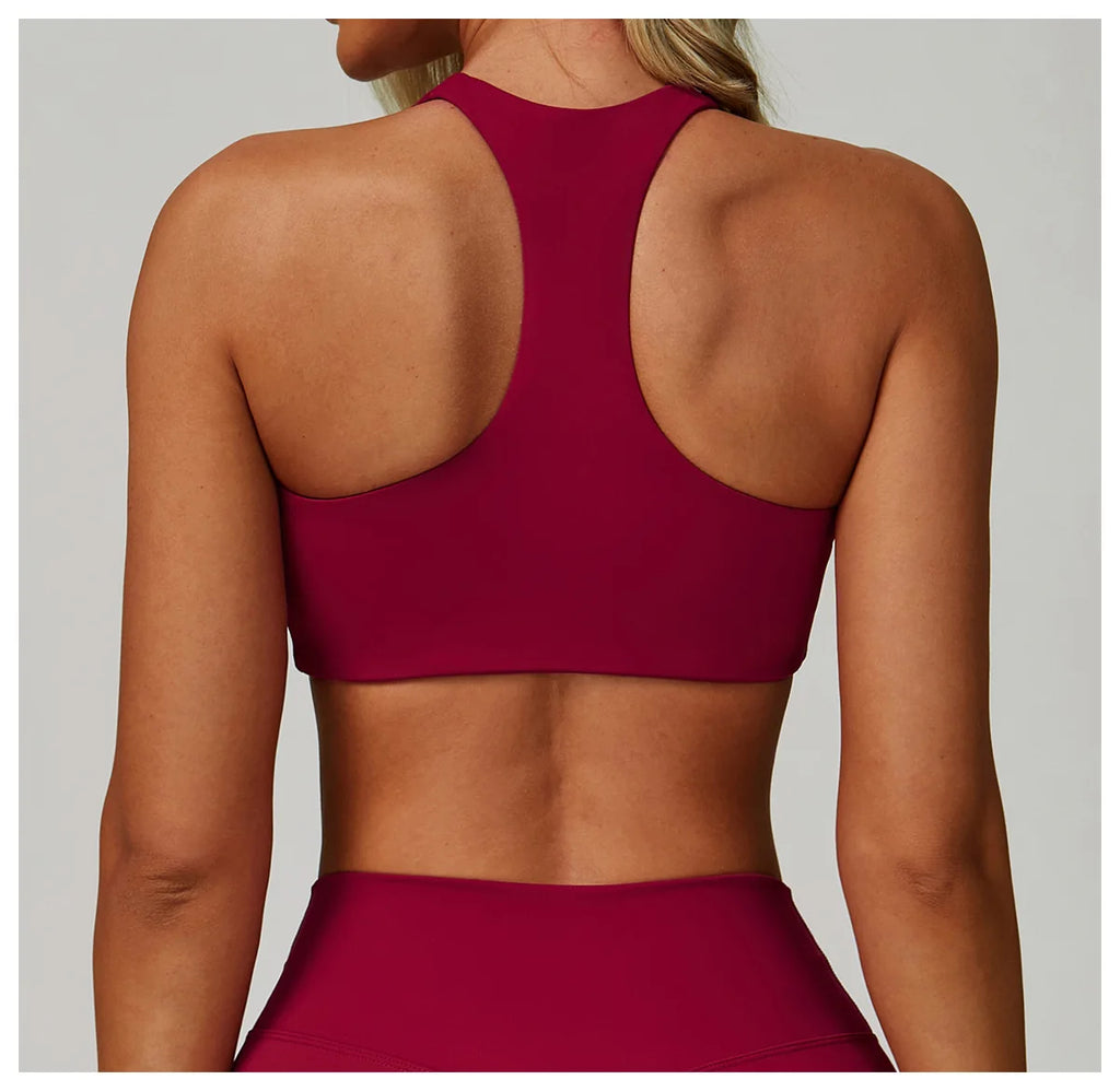 Rose red high-support sports bra with racerback and open-back eye panel.