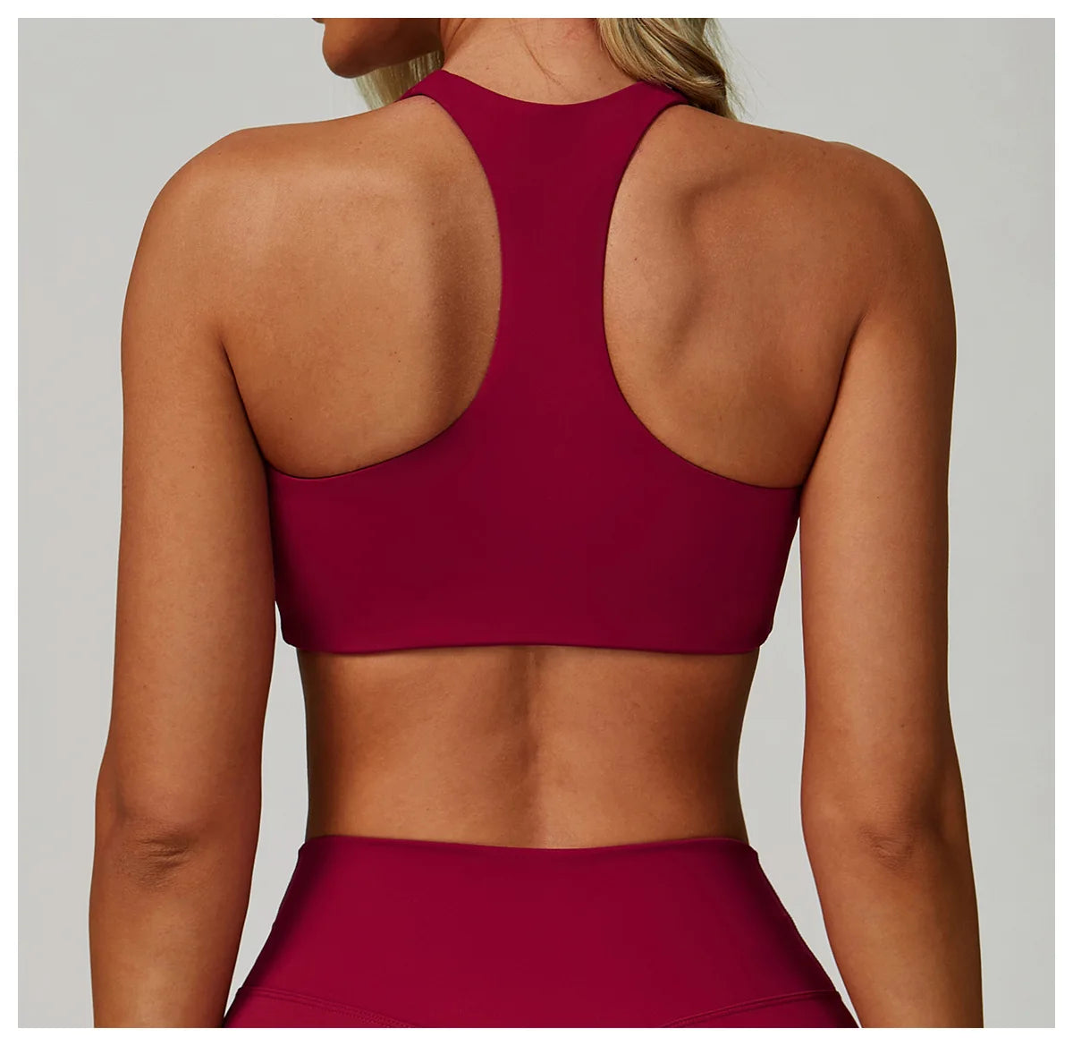 Rose red high-support sports bra with racerback and open-back eye panel.