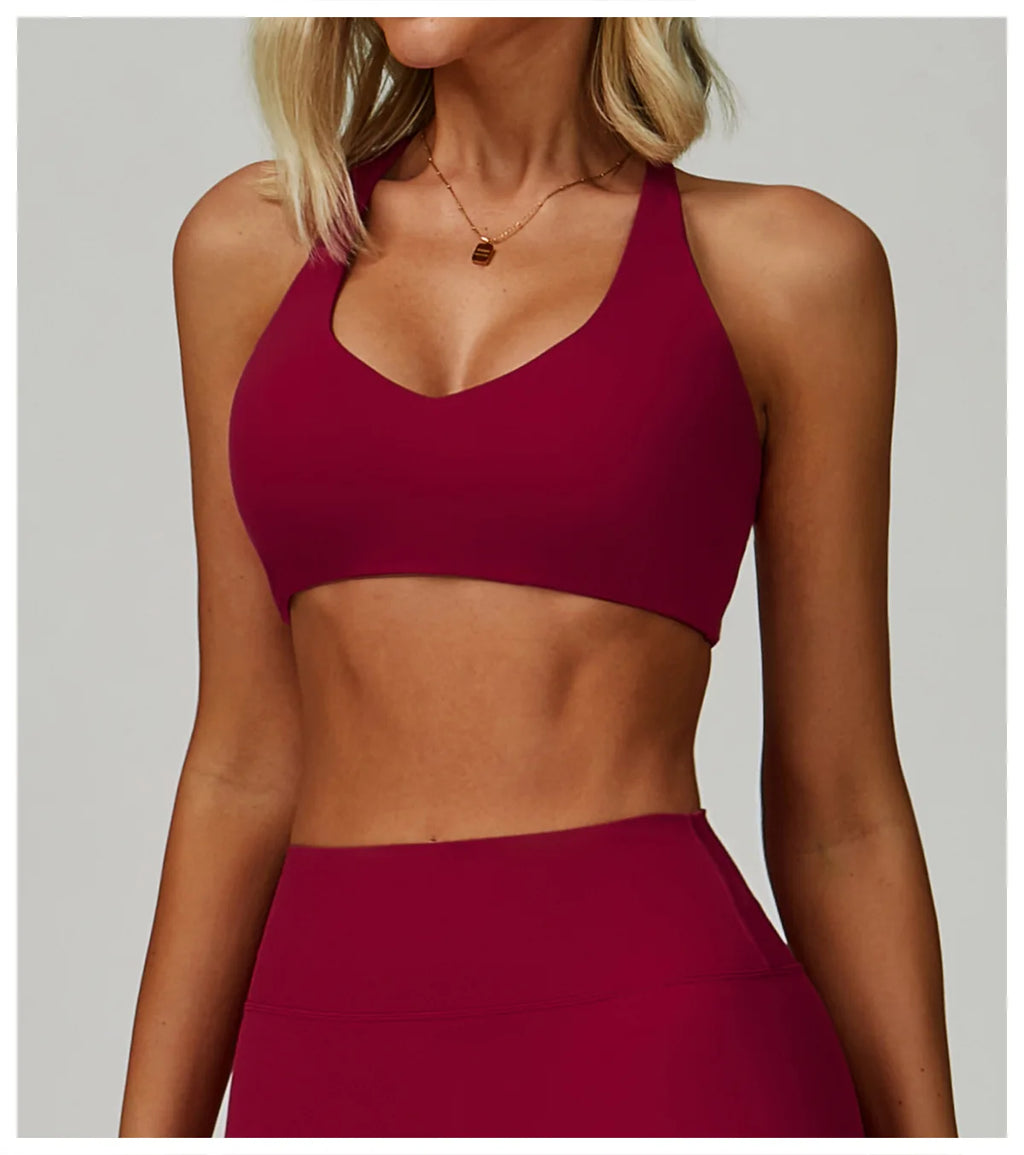 Rose red high-support sports bra with V-neck front and wide straps.