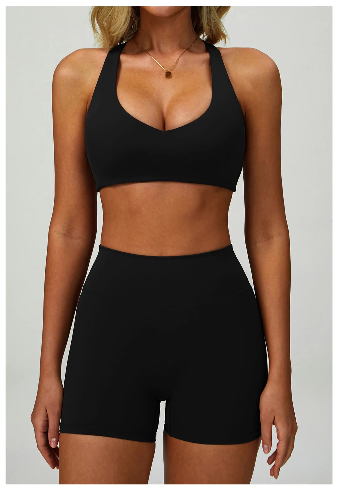 Black high-support sports bra with V-neck front and wide racerback straps.