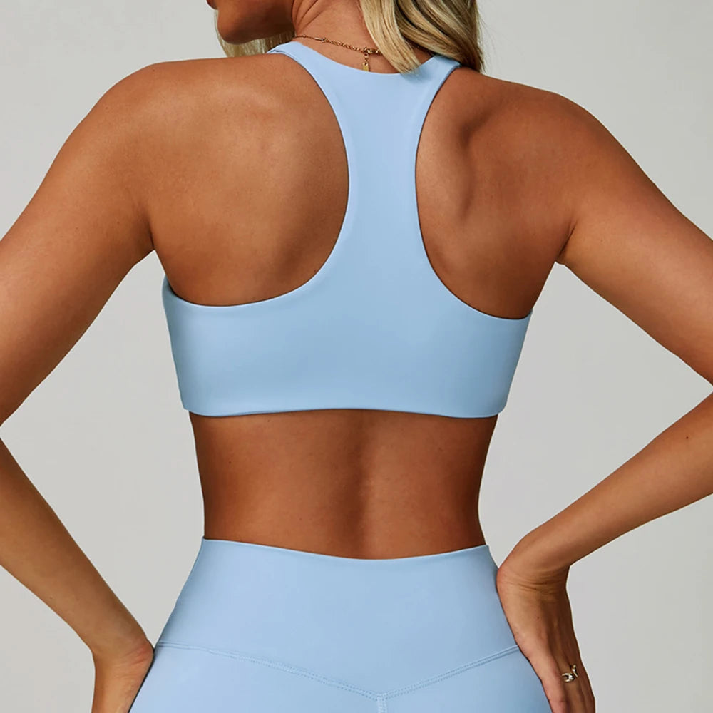 Sky blue high-support sports bra, racerback style, open back panel.