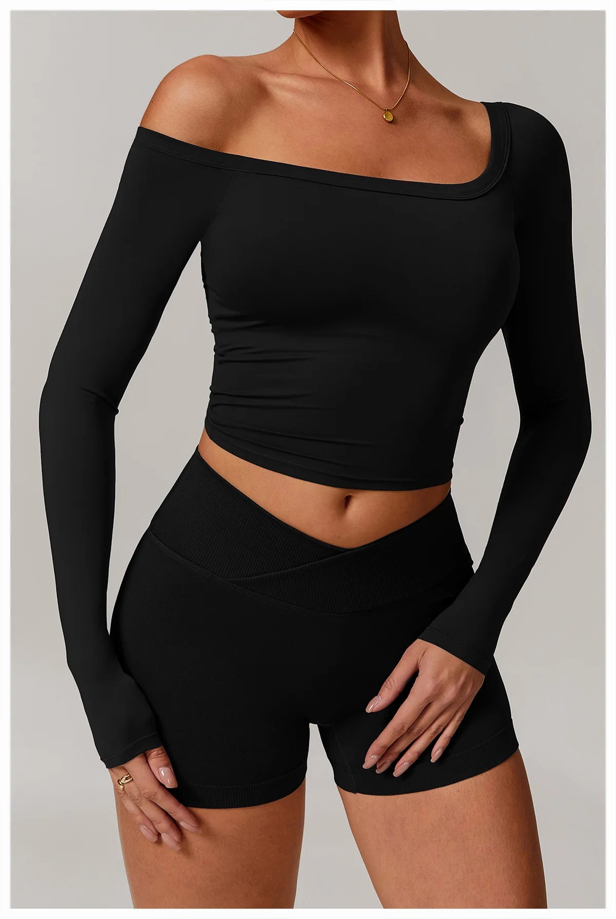 Xooie Fit stretchy long-sleeve workout shirt in black with off-shoulder design and fitted style