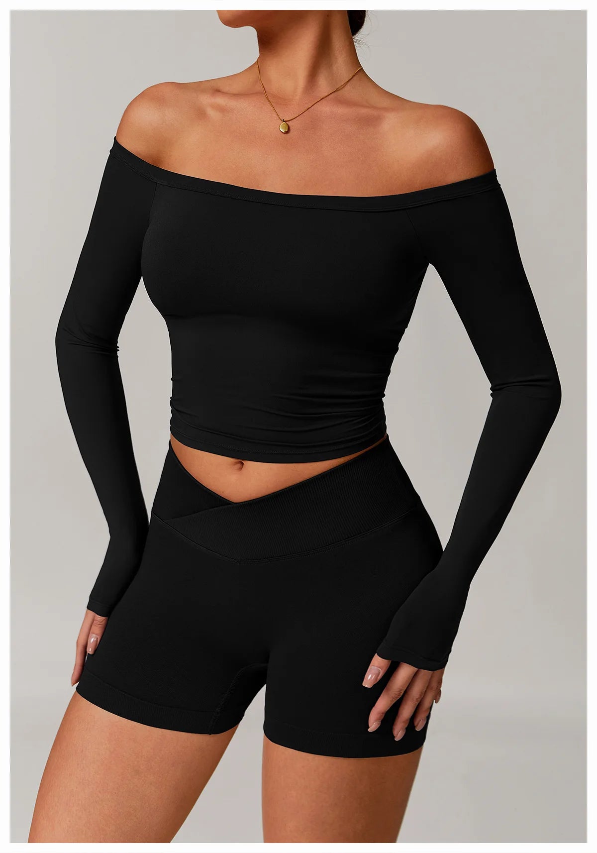 Xooie Fit black stretchy long-sleeve workout shirt with off-shoulder design and thumb holes