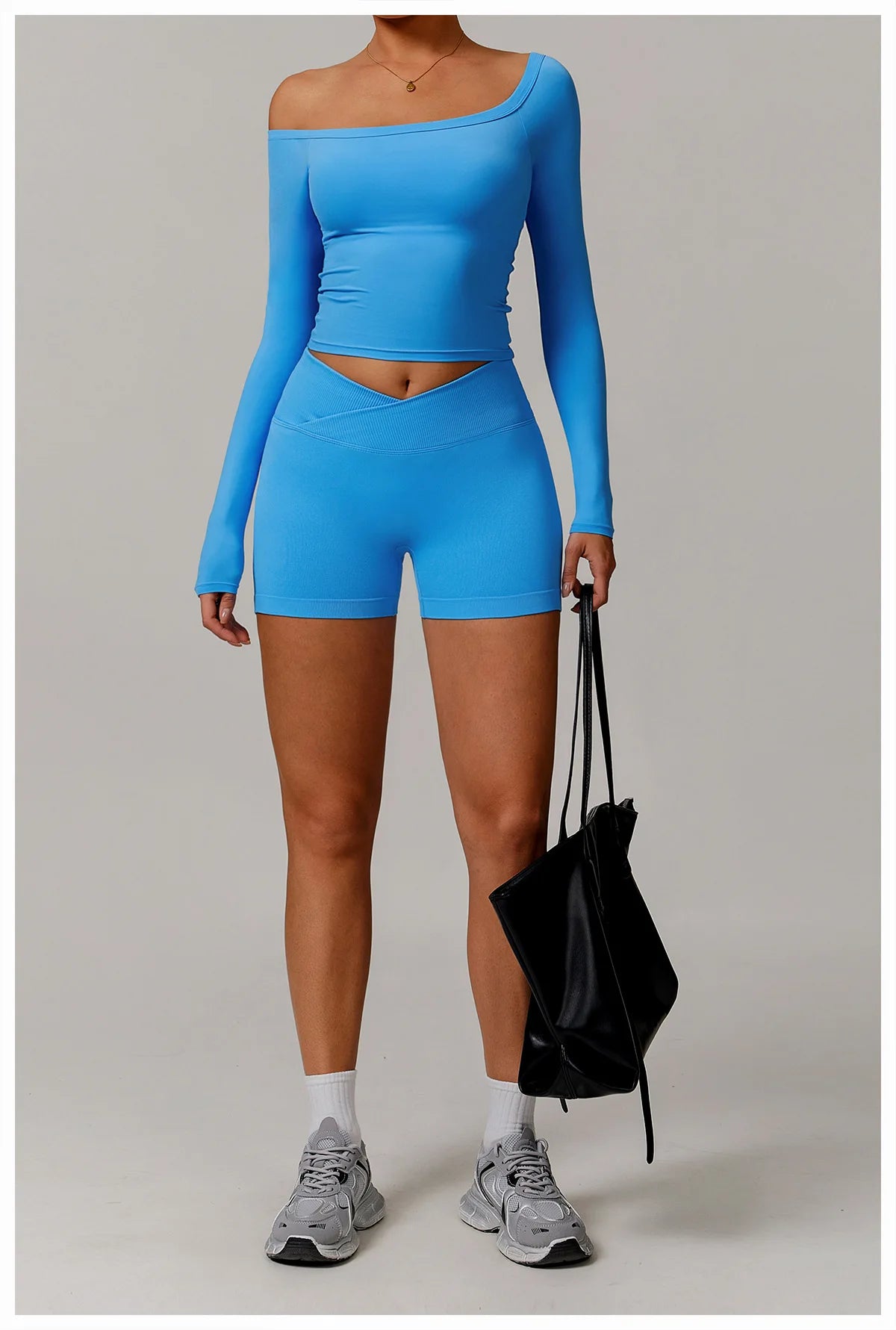 Xooie Fit stretchy long-sleeve workout shirt in blue worn with matching shorts and sneakers