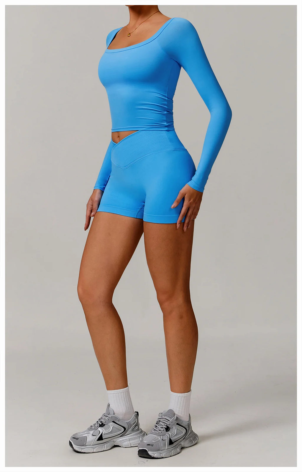 Xooie Fit stretchy long-sleeve workout shirt in bright blue shown with matching shorts and athletic shoes