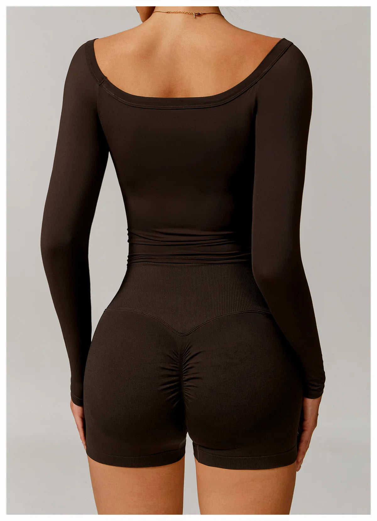 Xooie Fit black stretchy long-sleeve workout shirt showing back detail and fitted design