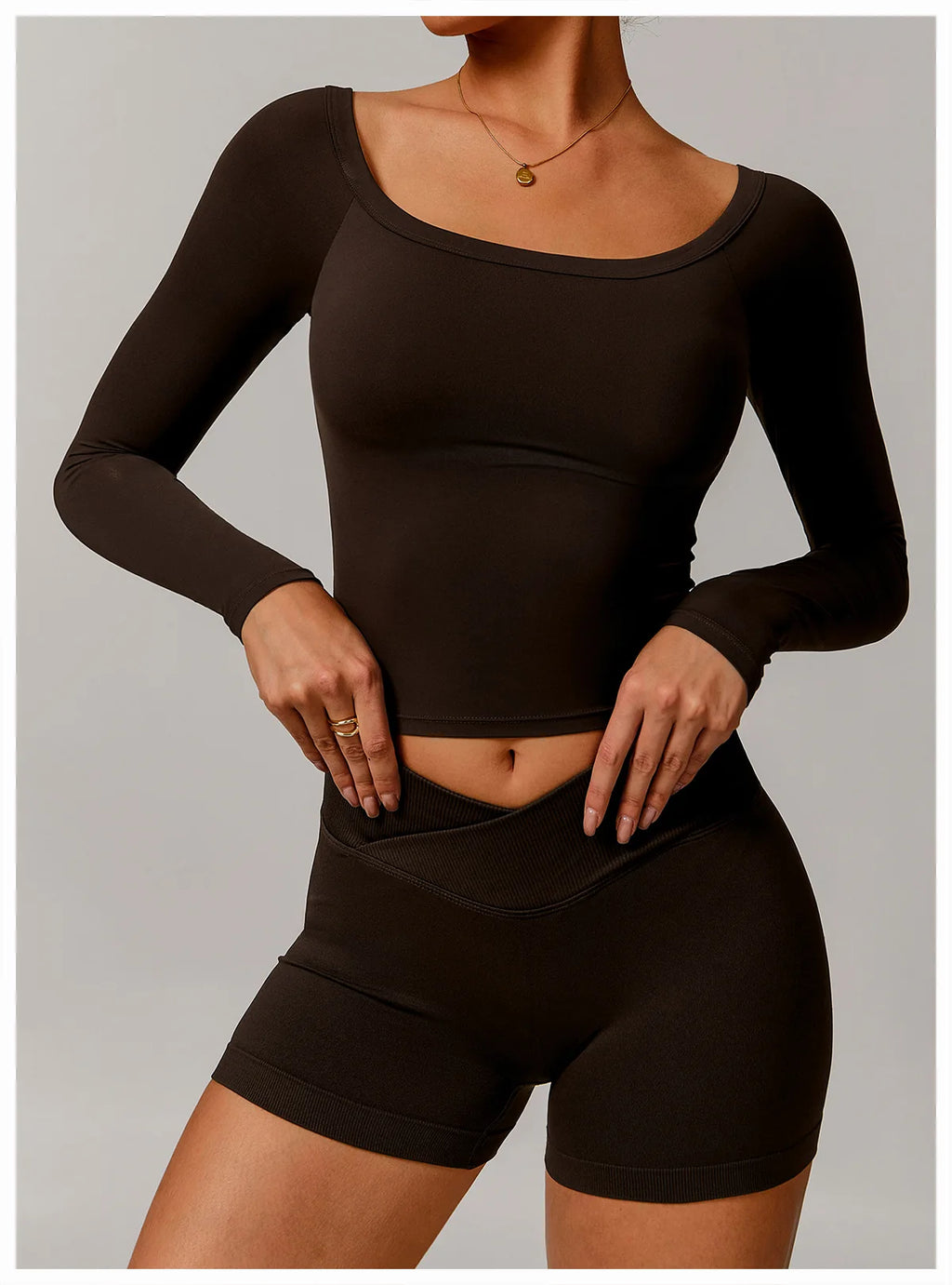 Xooie Fit black stretchy long-sleeve workout shirt with scoop neckline on model