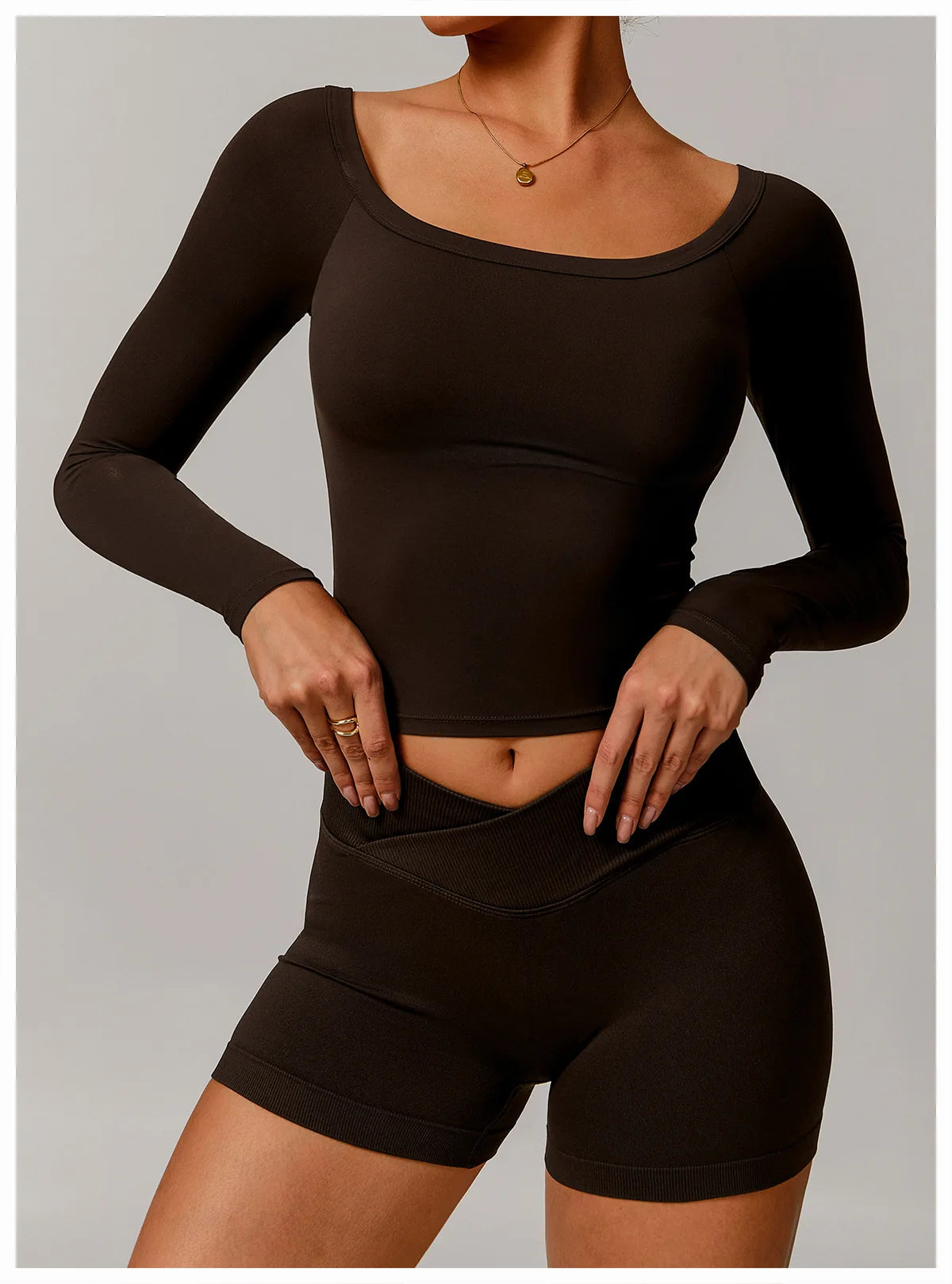 Xooie Fit black stretchy long-sleeve workout shirt with scoop neckline on model
