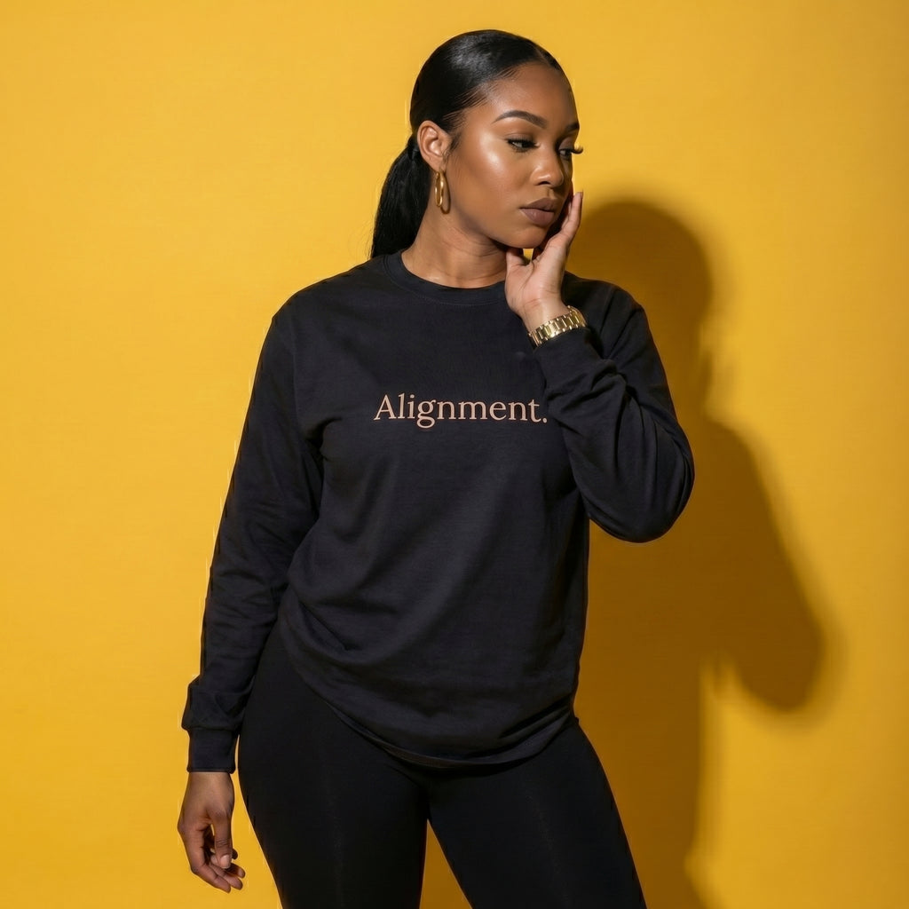 Black long-sleeve unisex tee with “Alignment” graphic on the front