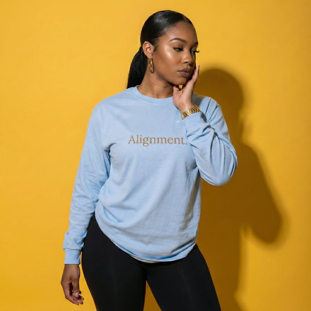 Light blue long-sleeve unisex tee with “Alignment” graphic on the front